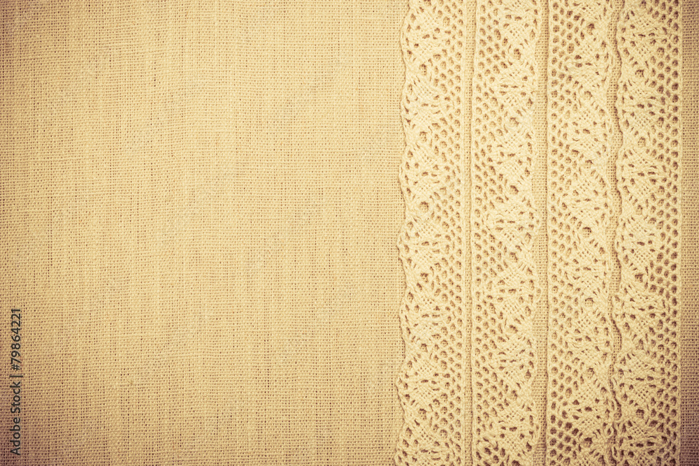 Fototapeta premium Lace ribbon on linen cloth background