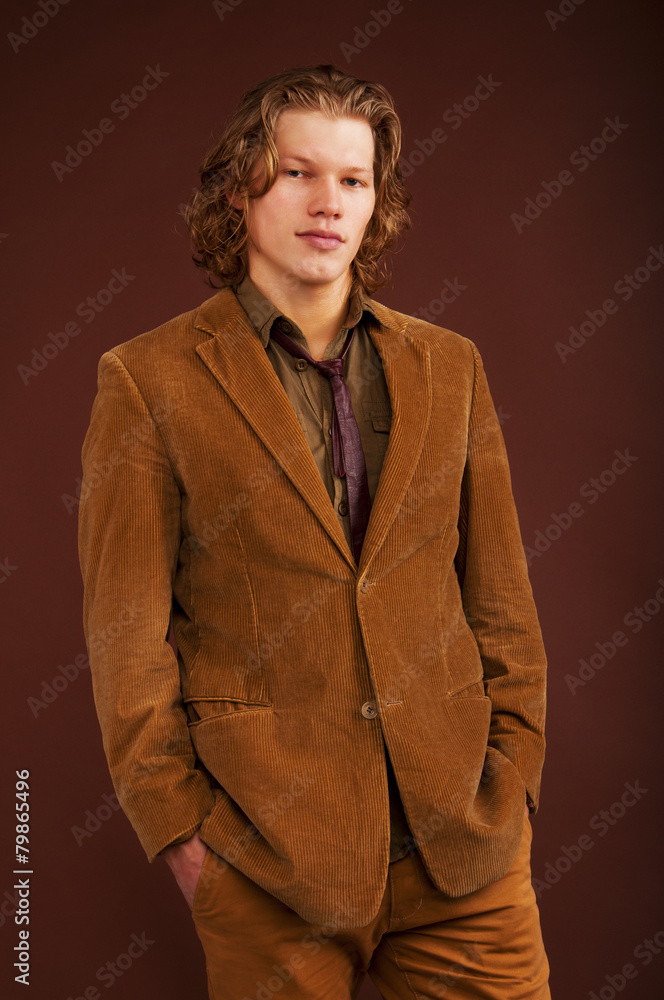 Young man in jacket isolated on brown background Young man in jacket isolated on brown background