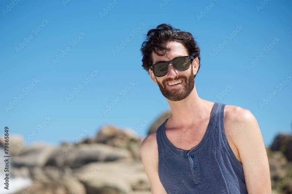 Happy young man smiling with sunglasses Happy young man smiling with sunglasses