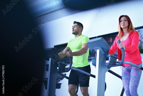 Group of people running on treadmills