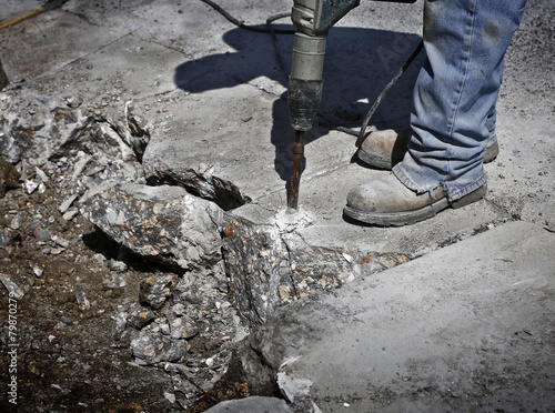 Man drilling cement concrete road