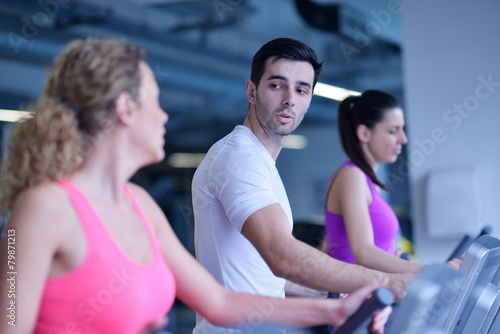 Group of people running on treadmills