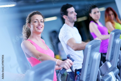 Group of people running on treadmills