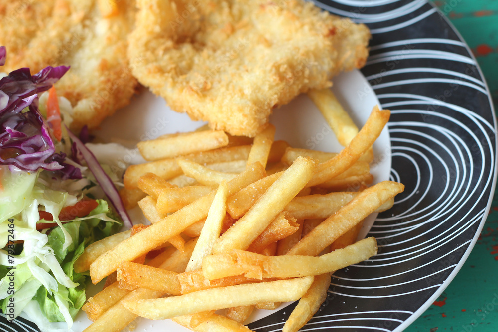 Steaks, french fries with vegetables salad on a plate. Steaks, french fries with vegetables salad on a plate.
