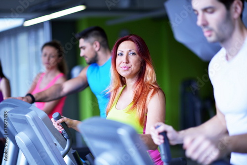 Group of people running on treadmills