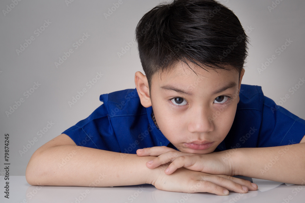 portrait of asian cute boy sad and  looking very disappointed