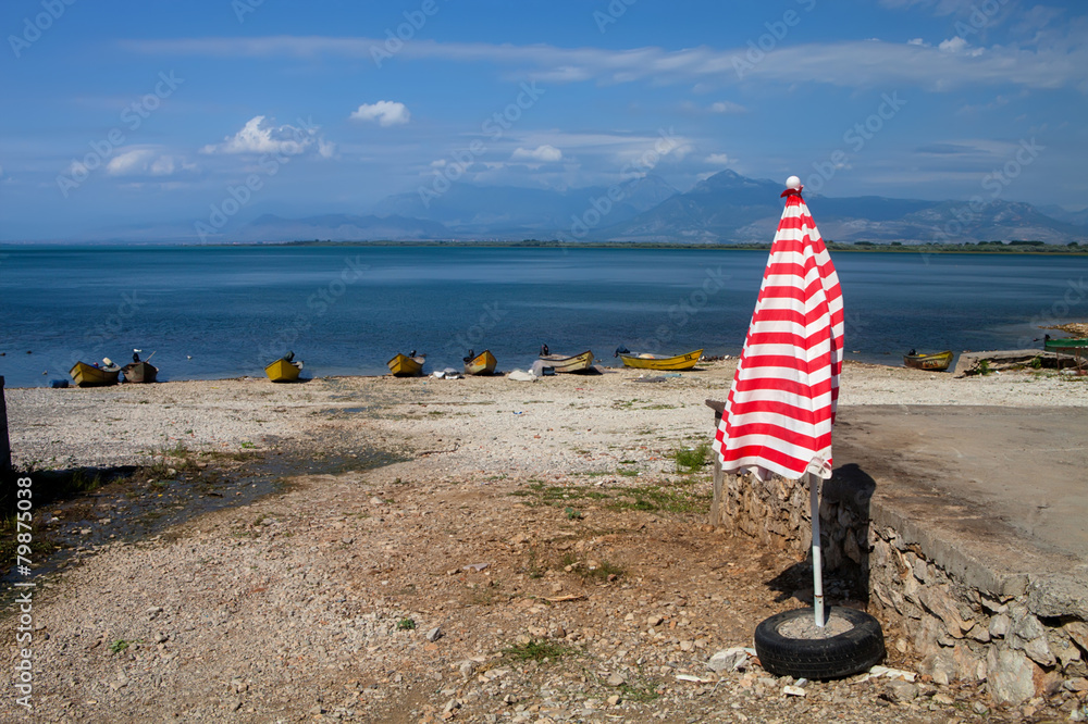 parasol on the shores of Lake Skadar, Albania parasol on the shores of Lake Skadar, Albania