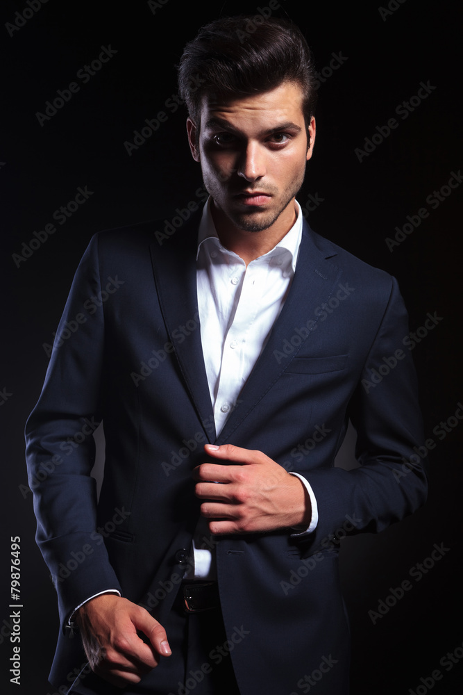 young business man unbuttoning his jacket young business man unbuttoning his jacket