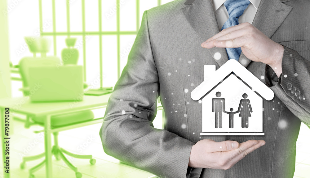 businessman protecting family in home with hands businessman protecting family in home with hands