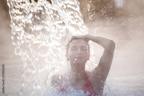 Young woman relaxing in thermal pool.