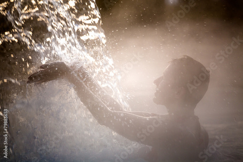 Young woman relaxing in thermal pool. photo