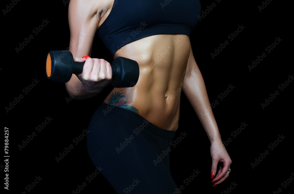 Beautiful brawny body of the woman with dumbbells Beautiful brawny body of the woman with dumbbells