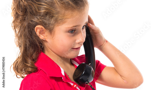 Blonde little girl with vintage phone