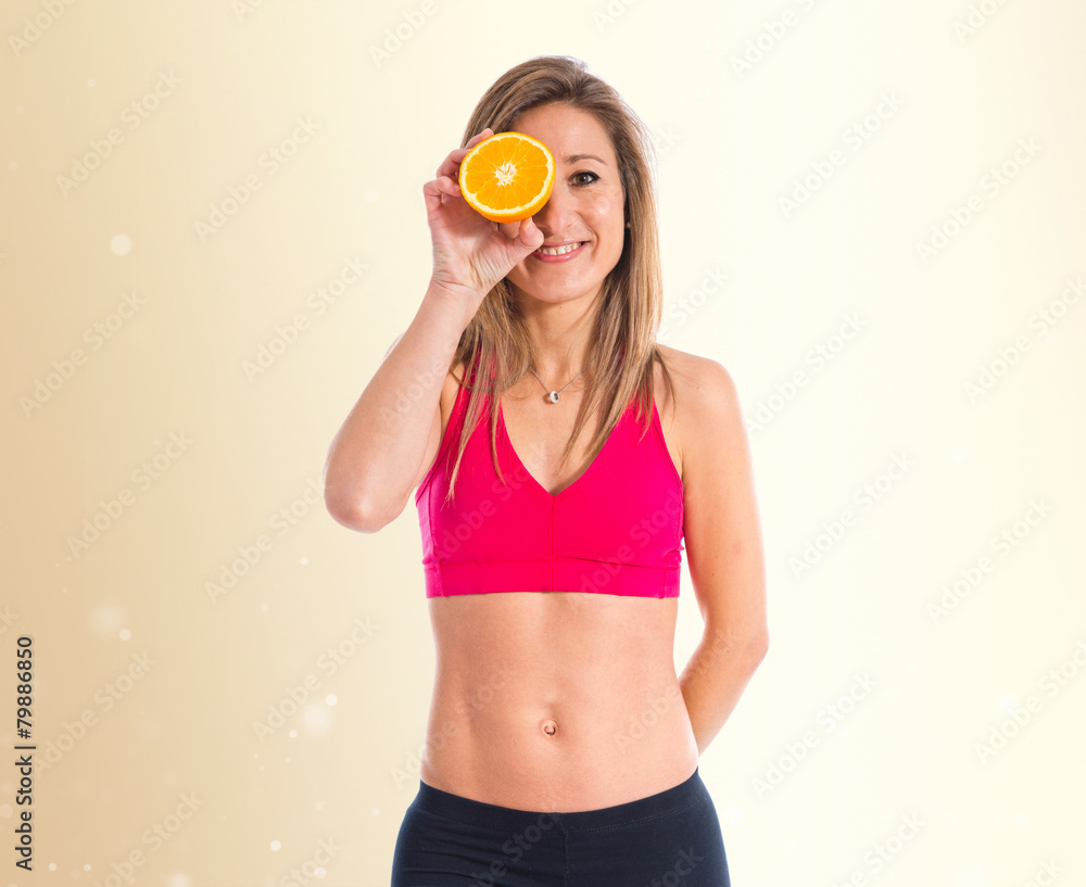 Sport woman holding an orange Sport woman holding an orange