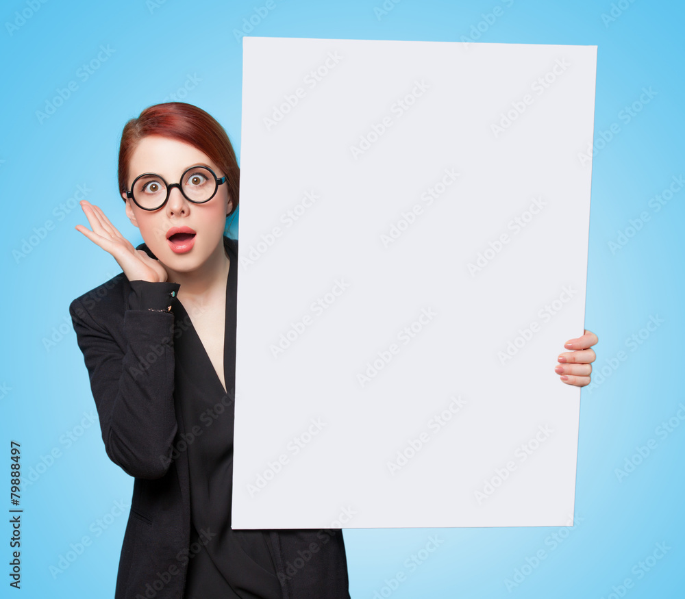Surprised redhead women with white board Surprised redhead women with white board