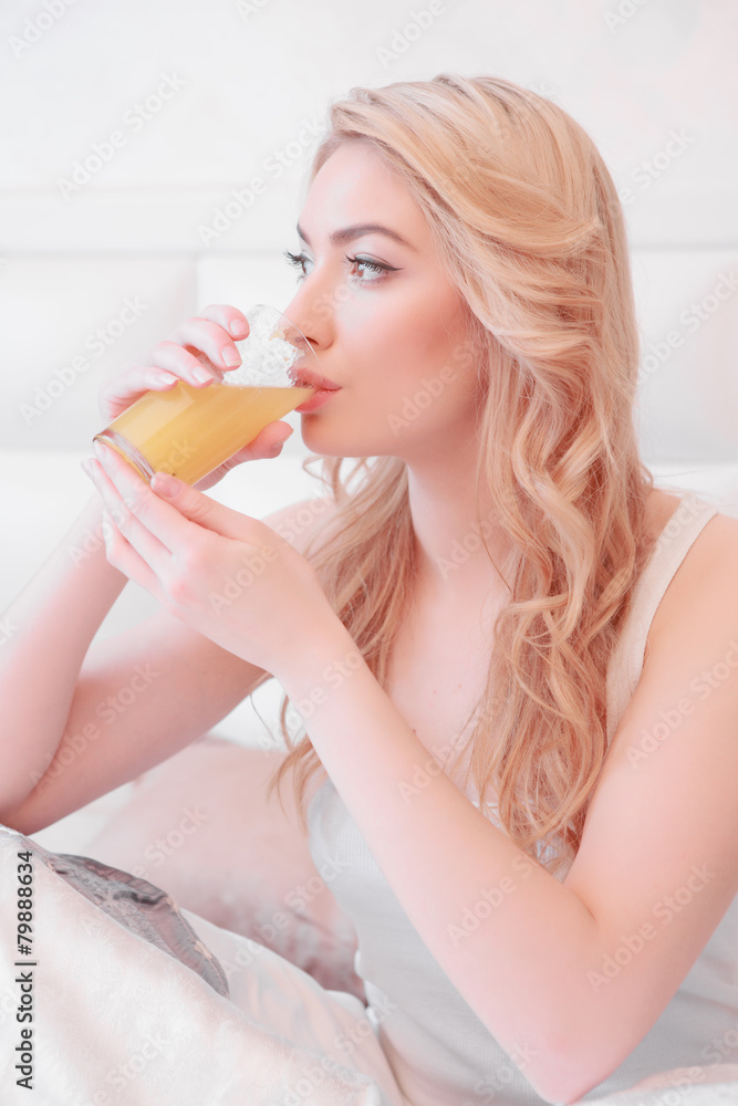 Young attractive woman having breakfast in bedroom Young attractive woman having breakfast in bedroom