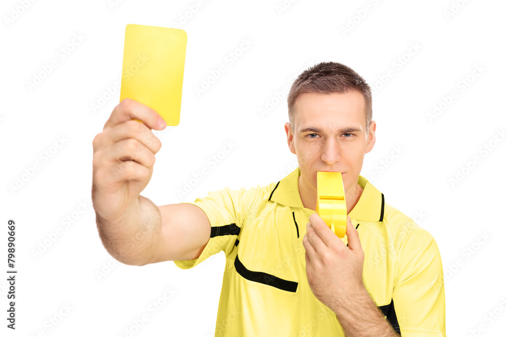 Referee showing yellow card and blowing huge whistle Referee showing yellow card and blowing huge whistle
