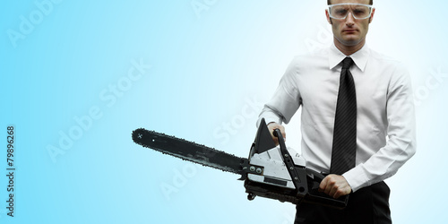 Businessman with chainsaw photo