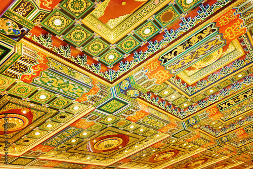 Gilded red patterns on the ceiling in interior of the Po Lin Mon