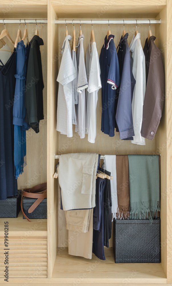 wooden closet with clothes hanging wooden closet with clothes hanging