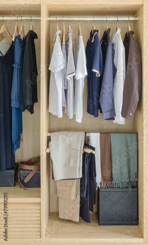 wooden closet with clothes hanging © 290712