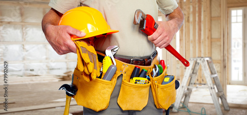 Builder handyman with construction tools.