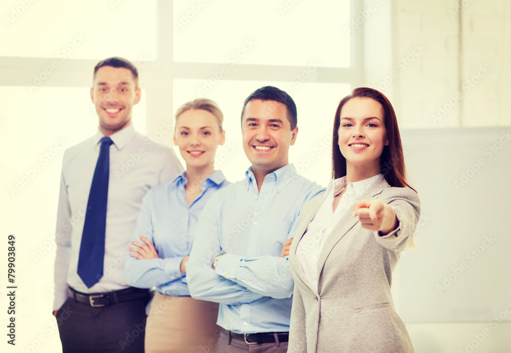 businesswoman in office pointing finger at you businesswoman in office pointing finger at you