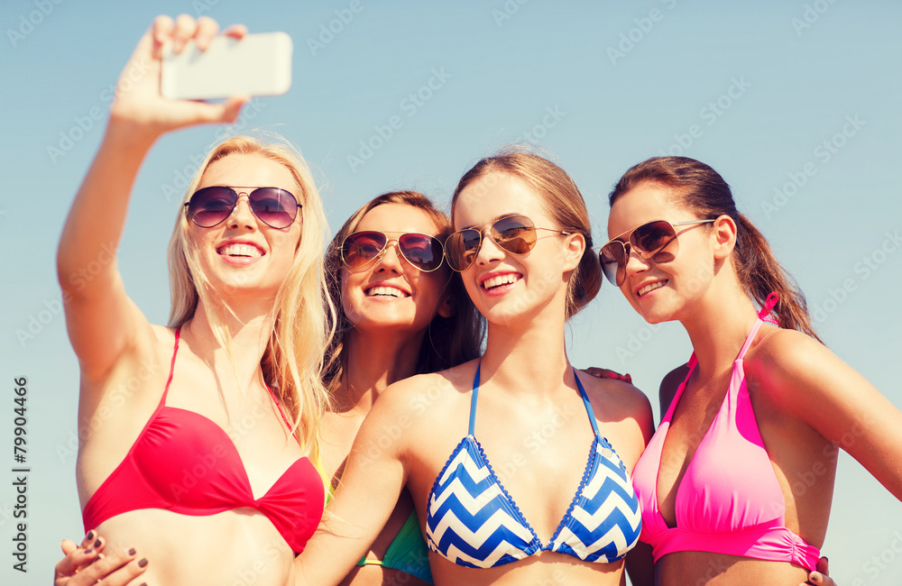 group of smiling women making selfie on beach group of smiling women making selfie on beach