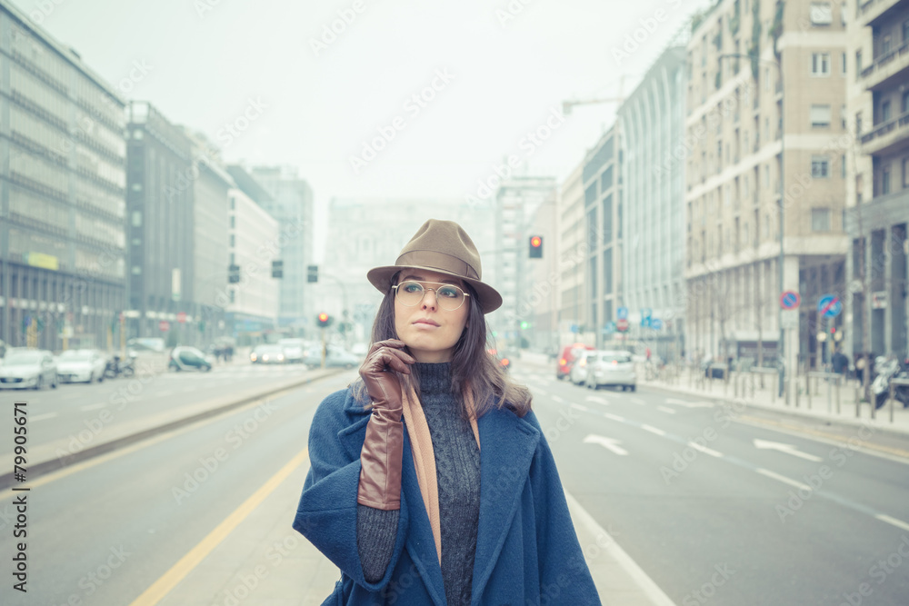 Beautiful young brunette posing in the city streets Beautiful young brunette posing in the city streets