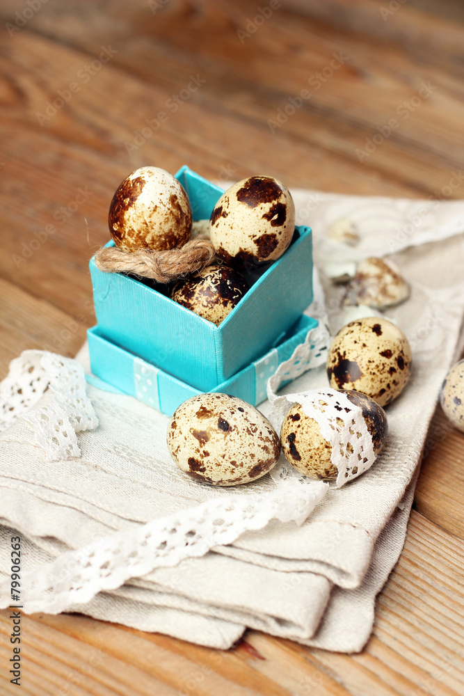 Quail eggs in a gift box lying on a wooden table Quail eggs in a gift box lying on a wooden table