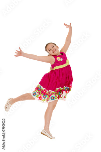 cheerful girl in a jump, hands wide apart