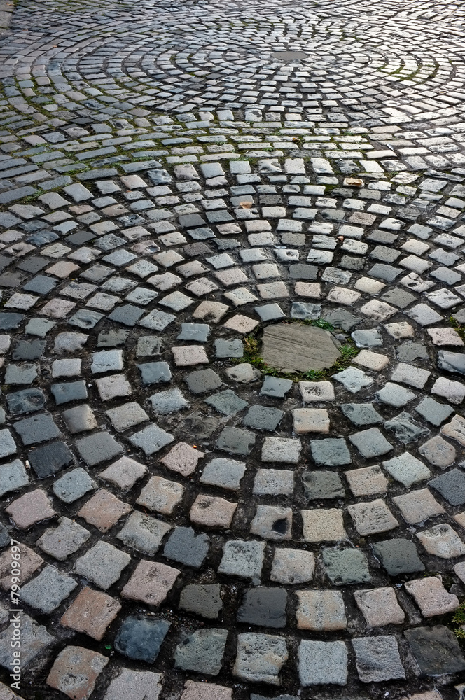 Old cobblestone street floor in circular pattern Old cobblestone street floor in circular pattern