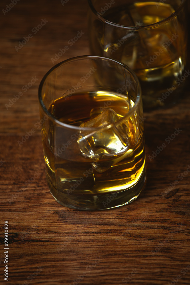 shot of whiskey on old wooden surface shot of whiskey on old wooden surface
