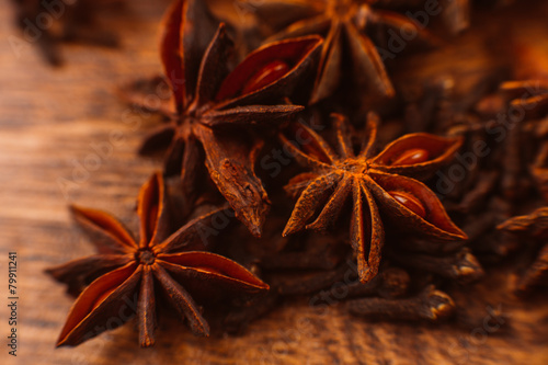 Cinnamon sticks with anise star on wooden background