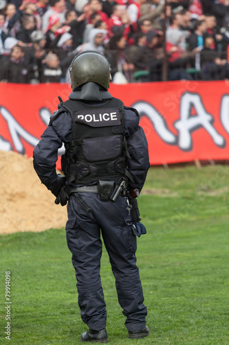 Police officer control fans to prevent football violence