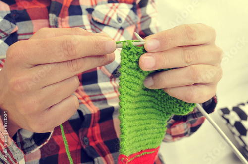 young man knitting photo
