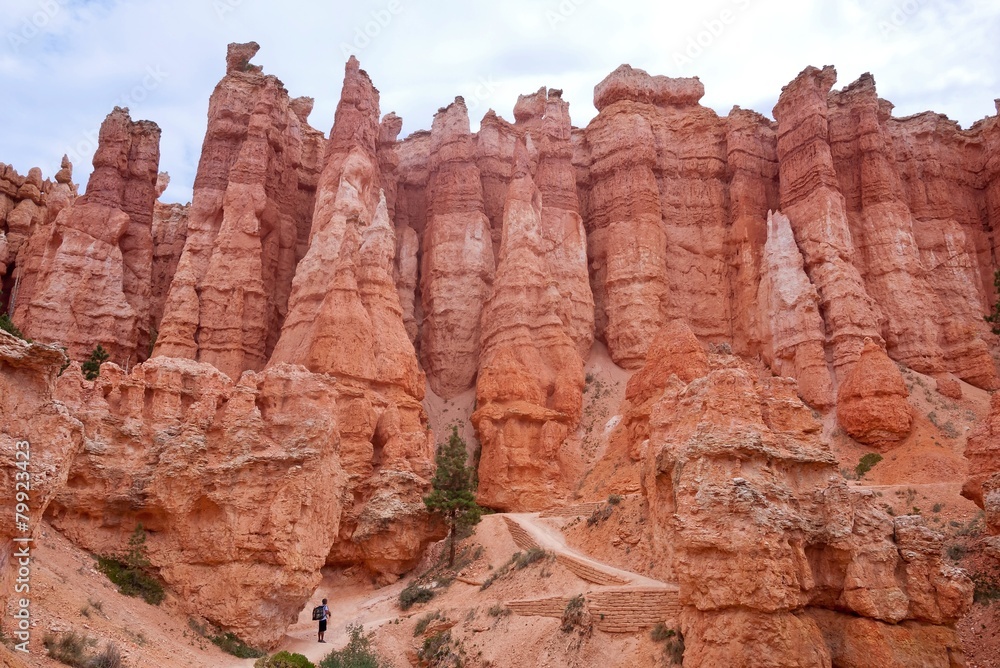 Hiker ascending out of red rocks at Bryce Canyon in Utah
