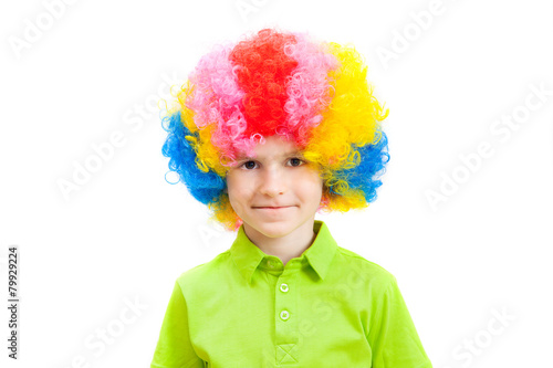 cute little boy in a multi-coloured clown wig