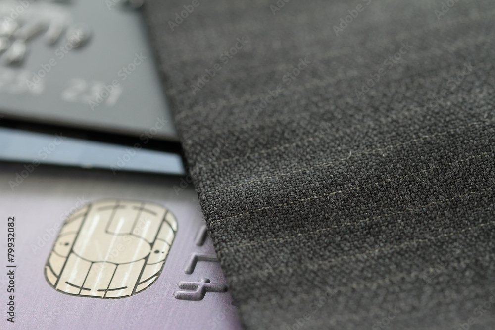 Credit cards in very shallow focus with gray suit background Credit cards in very shallow focus with gray suit background