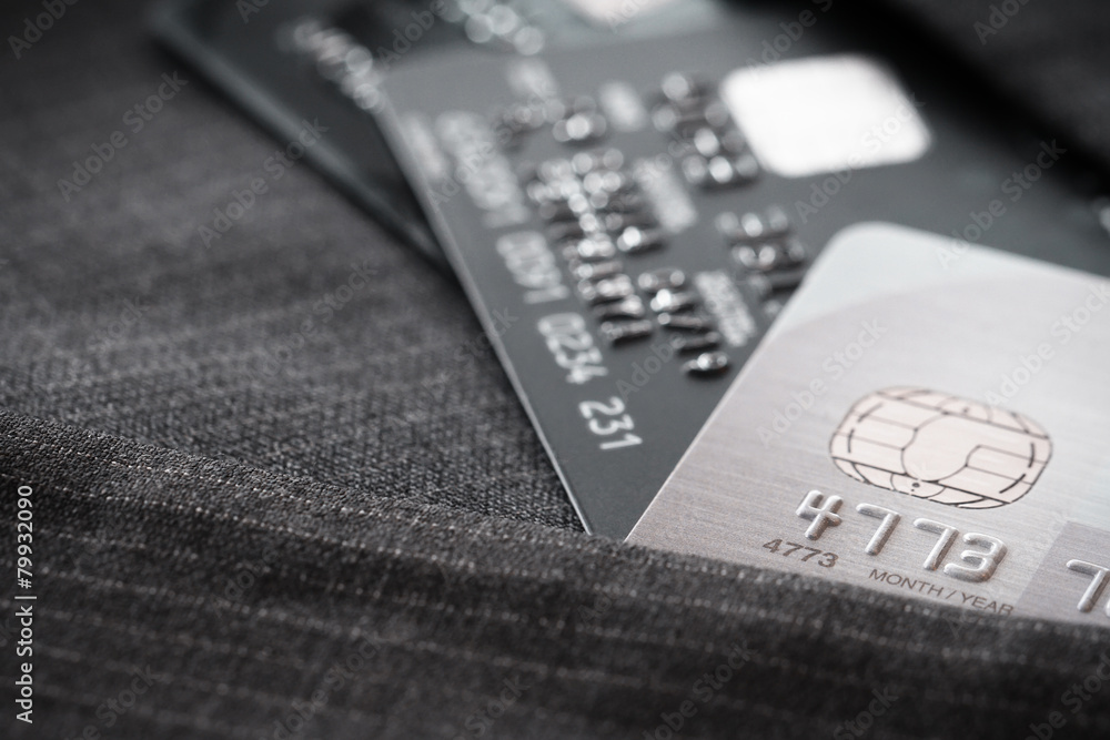 Credit cards in very shallow focus with gray suit background Credit cards in very shallow focus with gray suit background