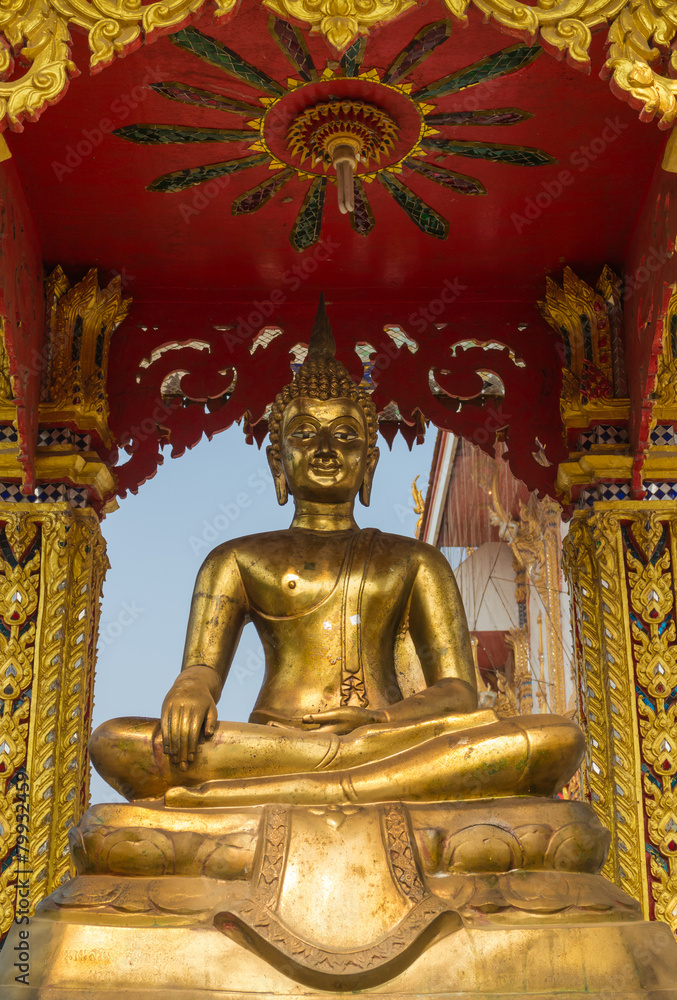 the gold buddha statue sitting under the sun light the gold buddha statue sitting under the sun light