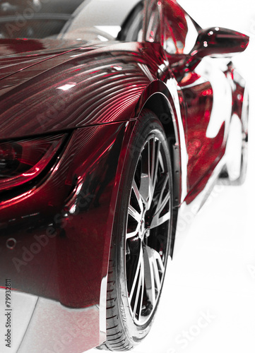 Part of red sports car model on white. © M-Production