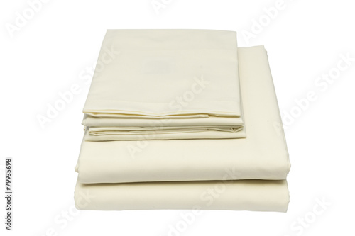 Folded bed linen on white isolated background