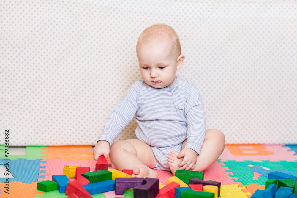 Cute little baby playing with colorful toys Cute little baby playing with colorful toys