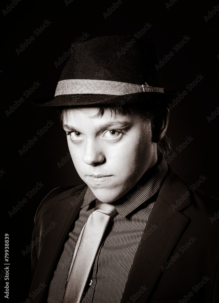 Affective teenage boy dressed in strong suit Affective teenage boy dressed in strong suit