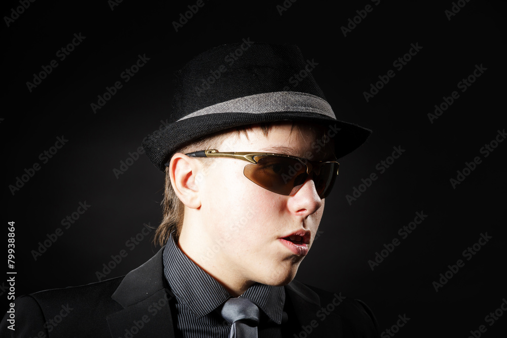 Affective teenage boy dressed in strong suit Affective teenage boy dressed in strong suit