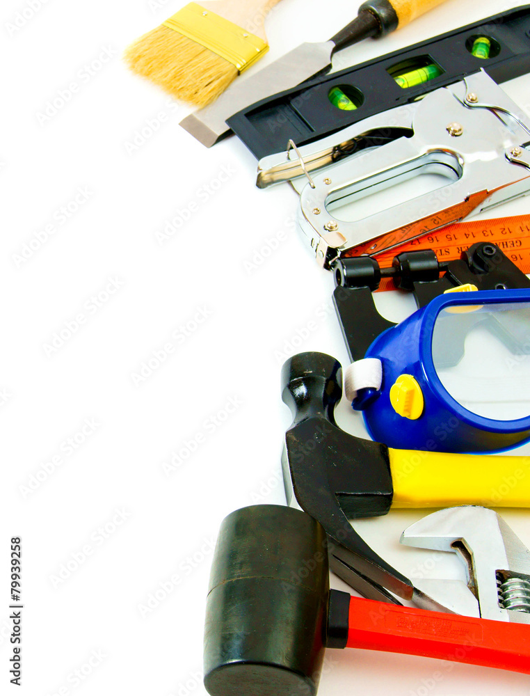 Many working tools - stapler, pliers and others on white Many working tools - stapler, pliers and others on white