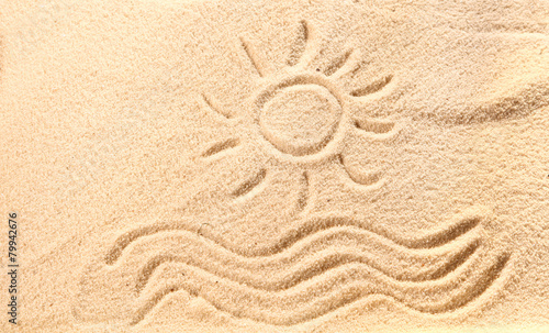 Drawing of waves and sun on beach sand