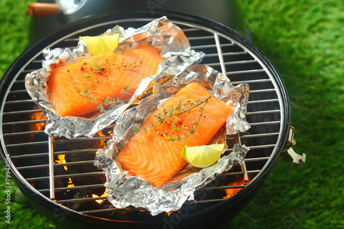 Salmon fillets grilling on an open fire