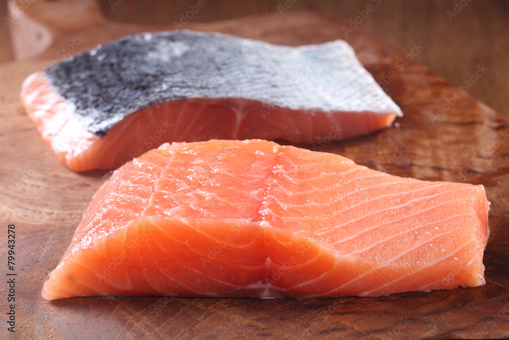 Raw Fresh Fish Meat on Wooden Chopping Board Raw Fresh Fish Meat on Wooden Chopping Board